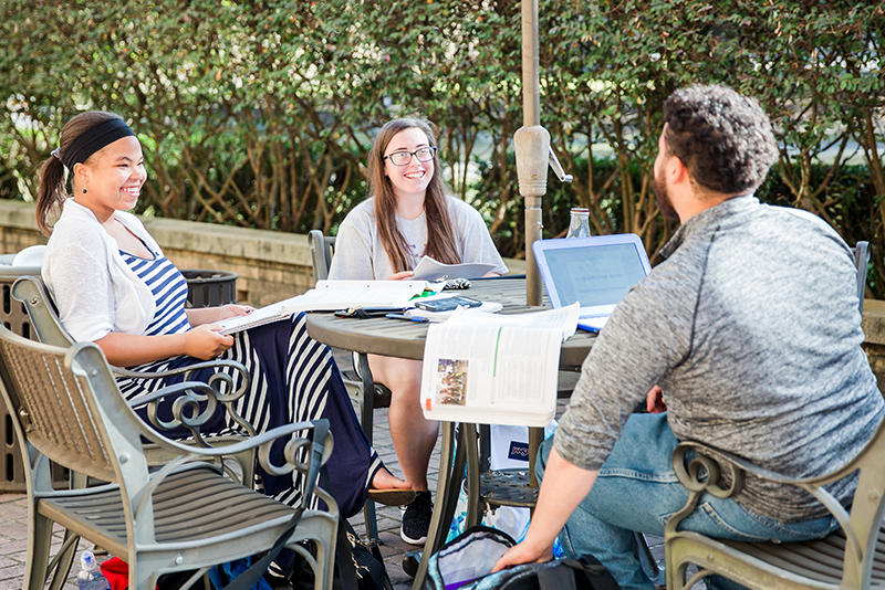 Photo of students at outside table